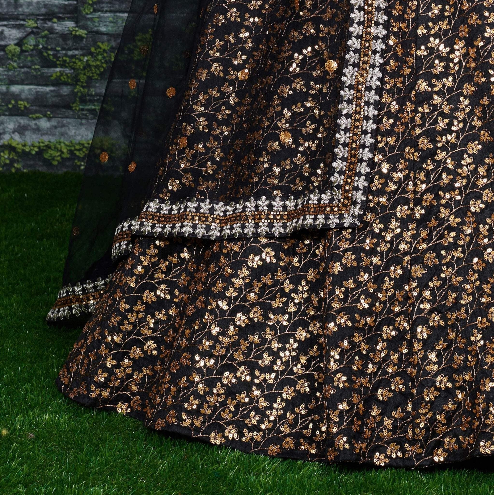Featuring a black[color] Raw silk leheng pattern with golden sequins all over le