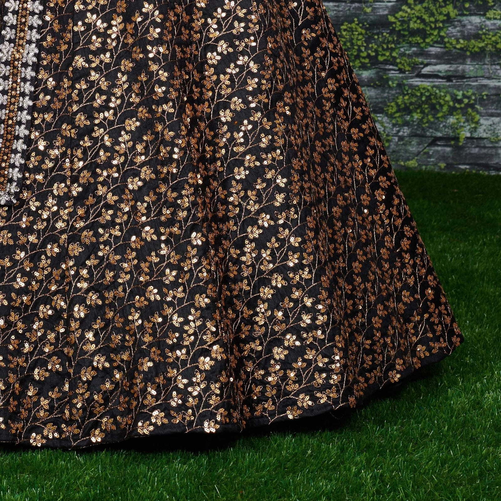 Featuring a black[color] Raw silk leheng pattern with golden sequins all over le