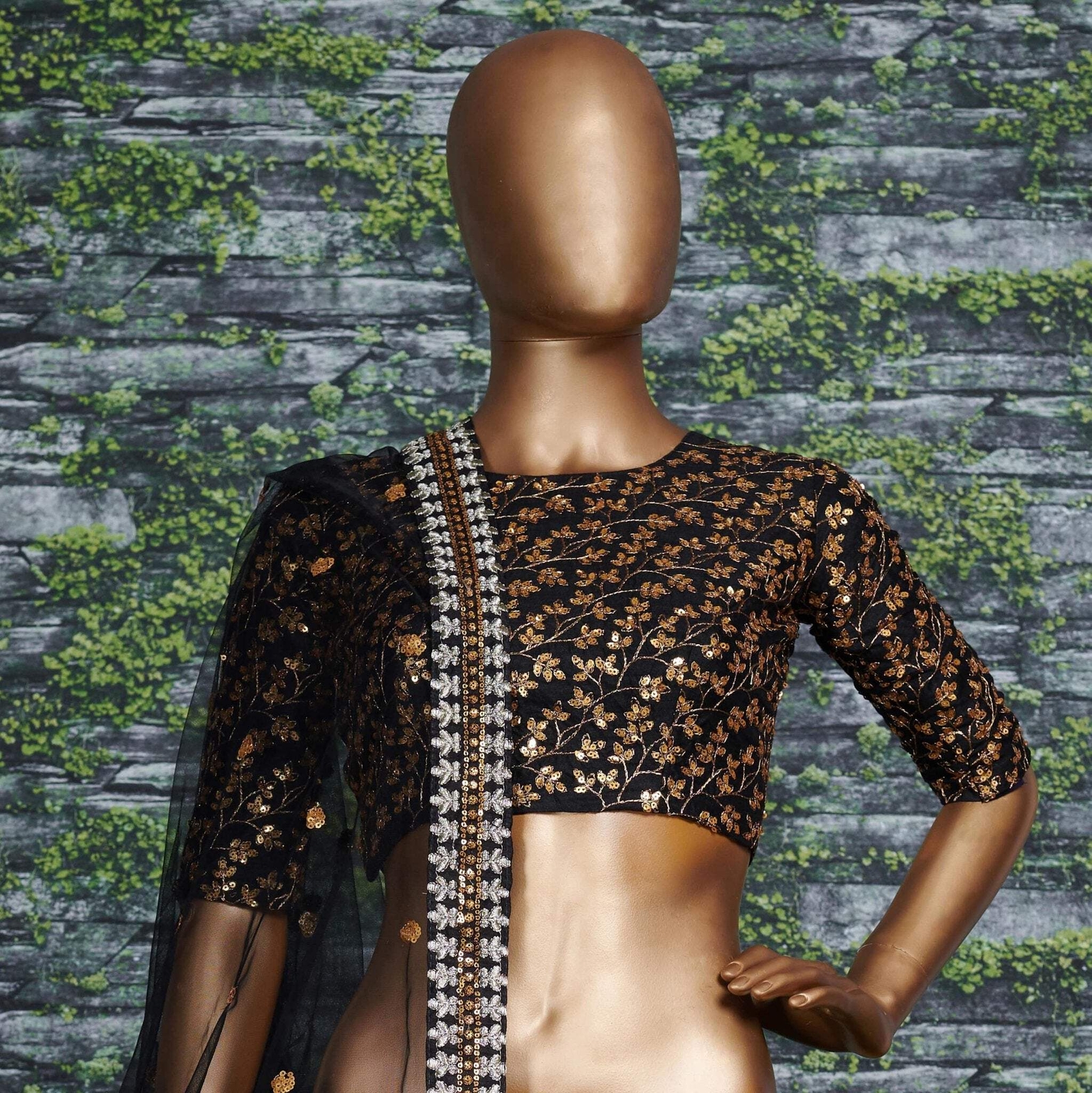 Featuring a black[color] Raw silk leheng pattern with golden sequins all over le
