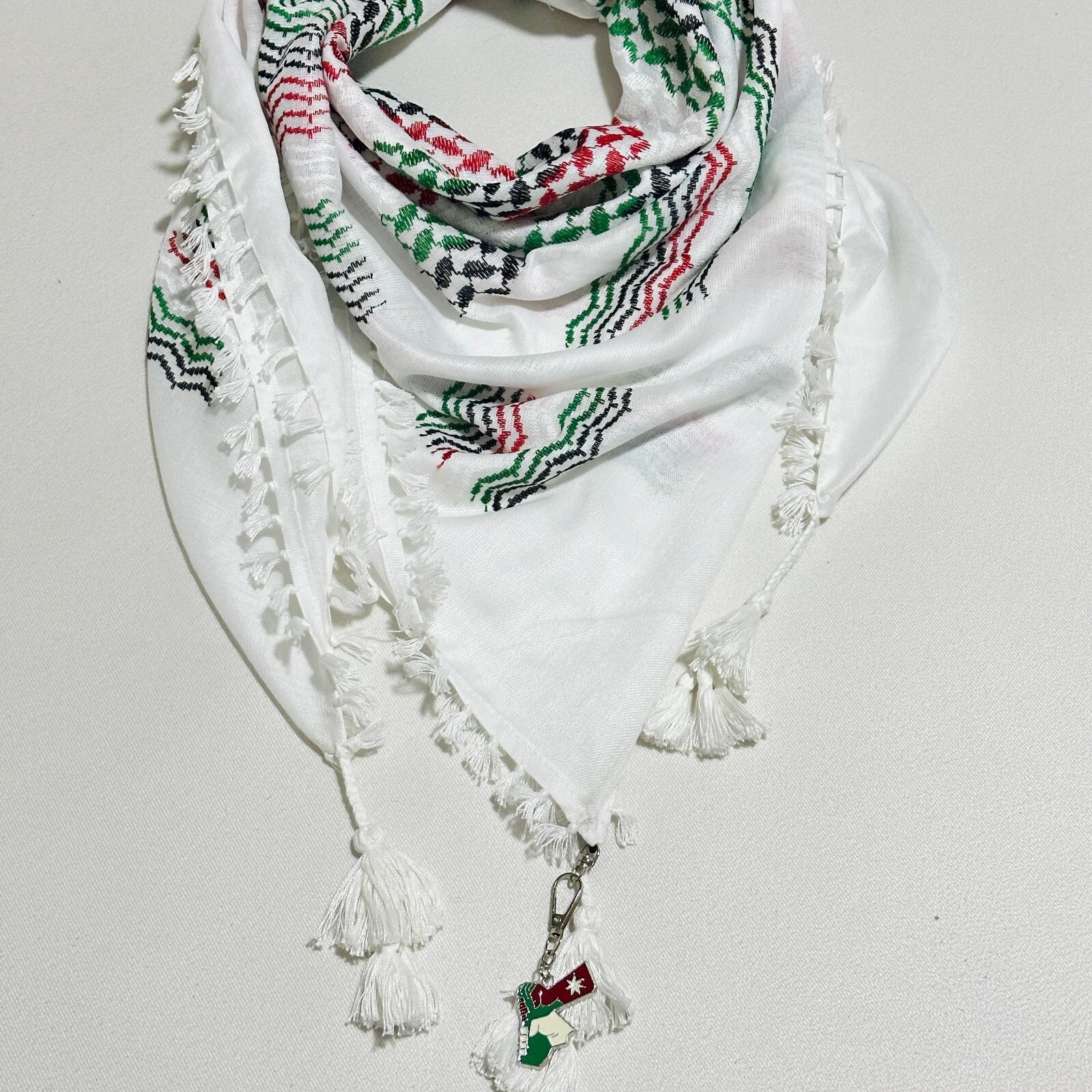 A Palestinian unisex keffiyeh featuring the Palestinian flag colors design.