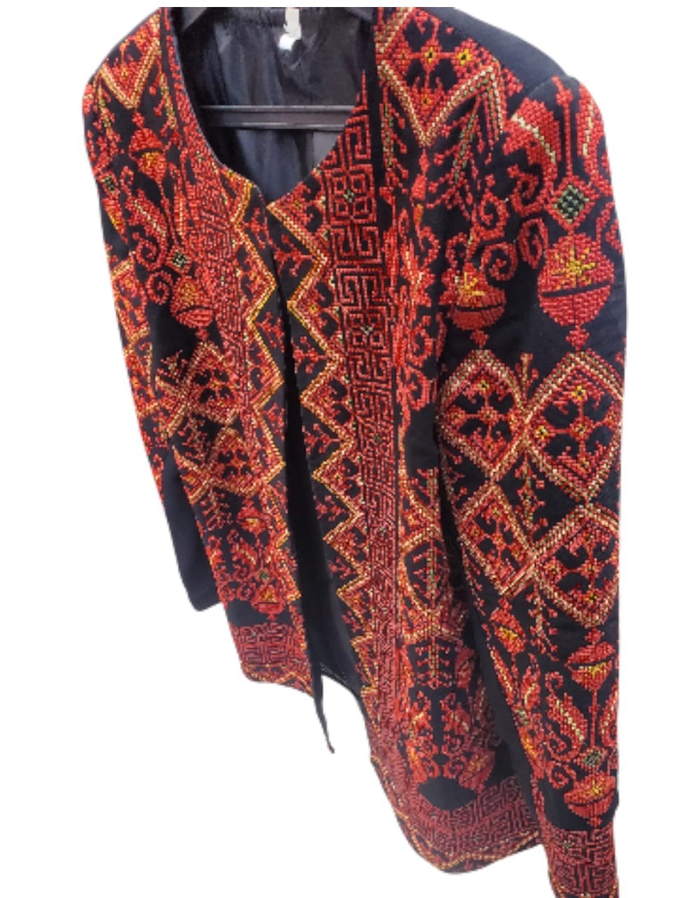 A hand-embroidered heritage jacket featuring traditional Arabic designs, in blac