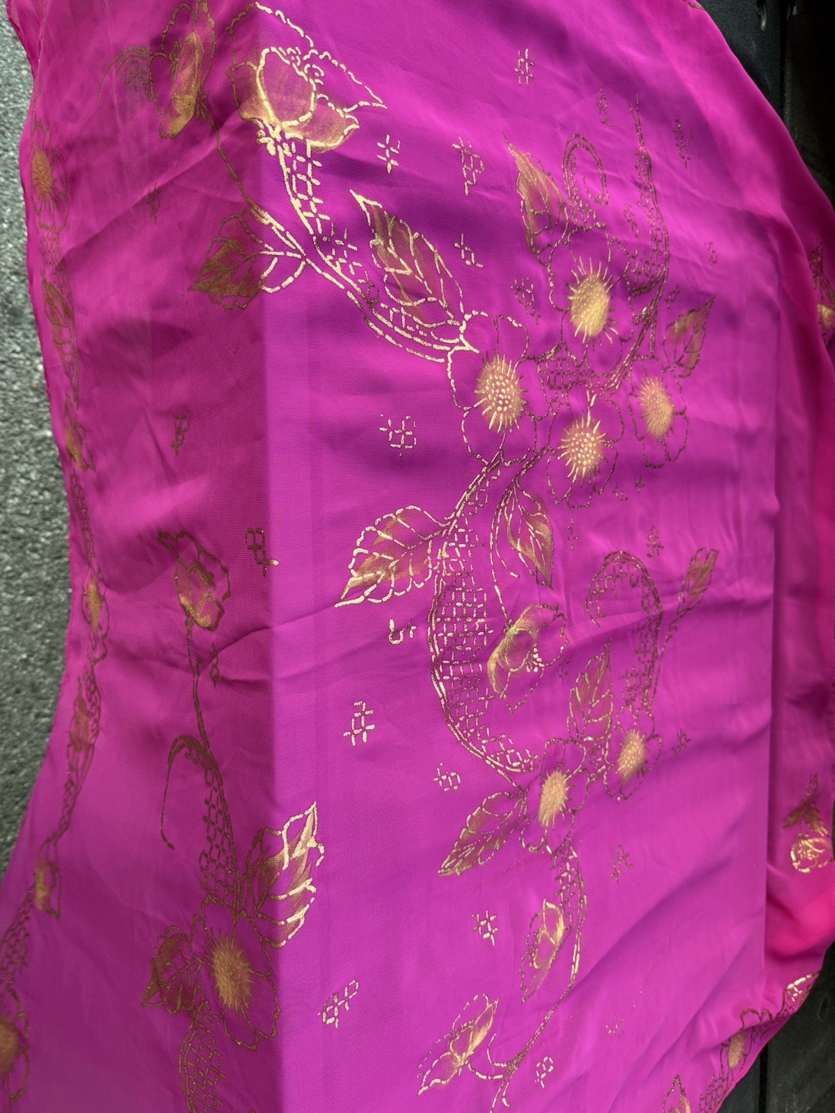 magenta sheer scarf with a gold floral pattern.