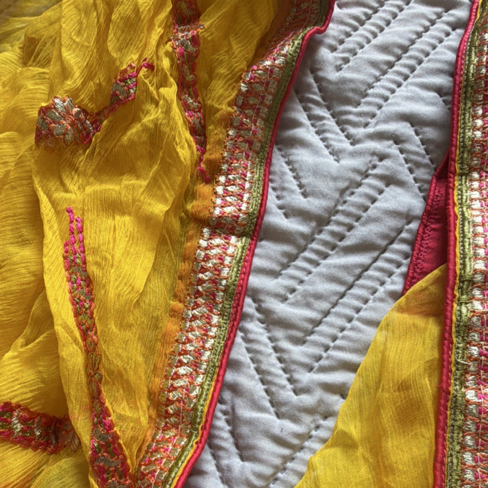 Yellow Chiffon Saree with Pink, Orange, and Gold Embroidered Border