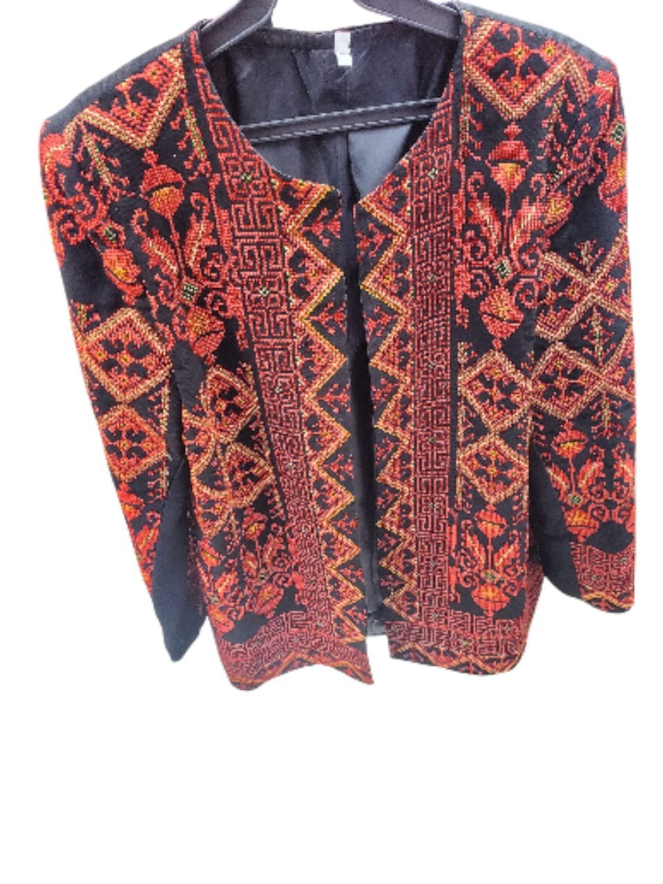 A hand-embroidered heritage jacket featuring traditional Arabic designs, in blac