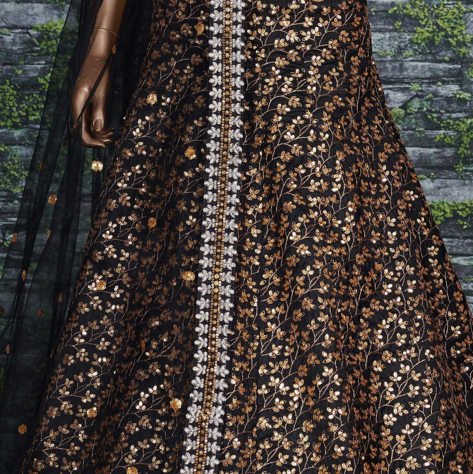 Featuring a black[color] Raw silk leheng pattern with golden sequins all over le