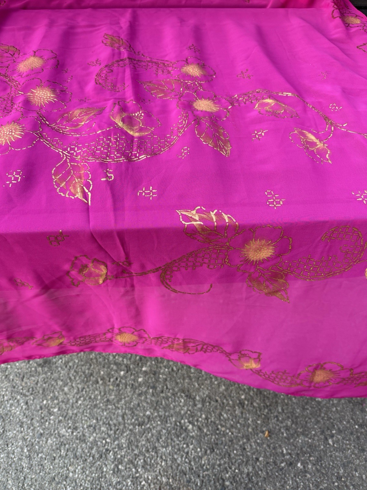 magenta sheer scarf with a gold floral pattern.