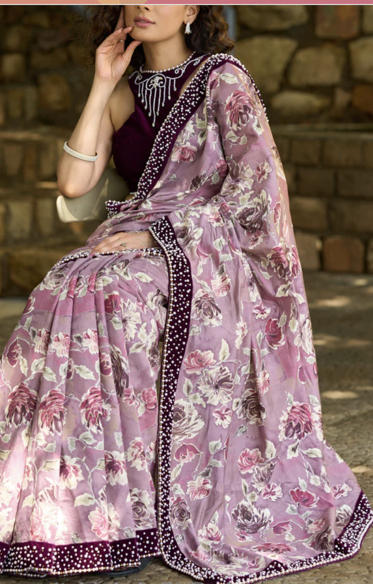 Gracious purple floral printed saree highlighted with velvet pearl embroidered