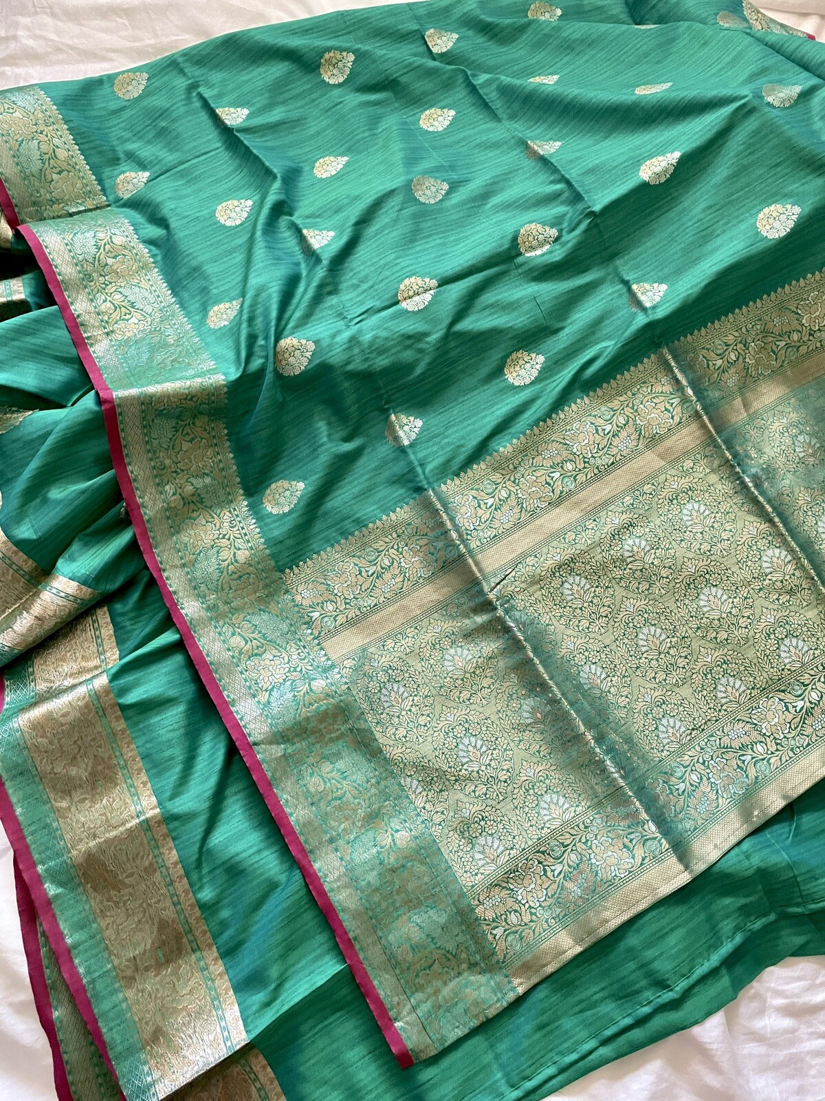 Beautiful teal-green silk saree dress with golden accents