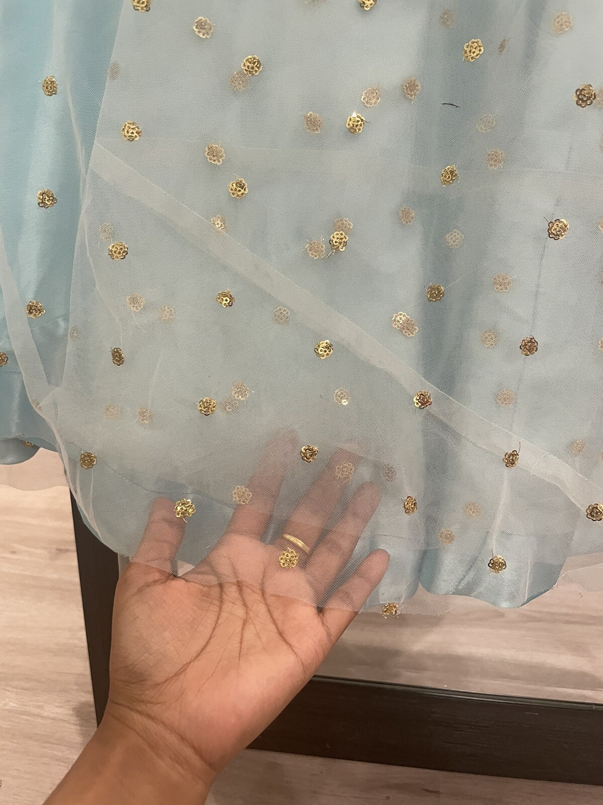 light blue net fabric lehenga with gold sequence work choli