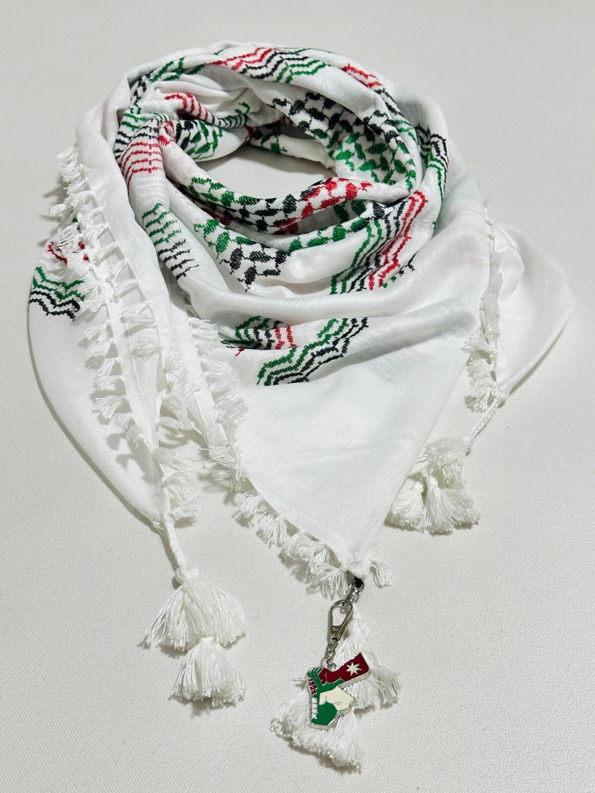 A Palestinian unisex keffiyeh featuring the Palestinian flag colors design.
